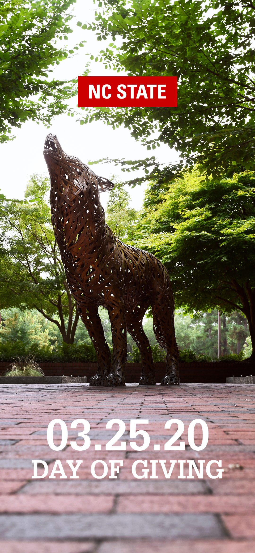 Picture of the howling Iron Wolf statue with text overlaid reading NC State Day of Giving 03.25.20