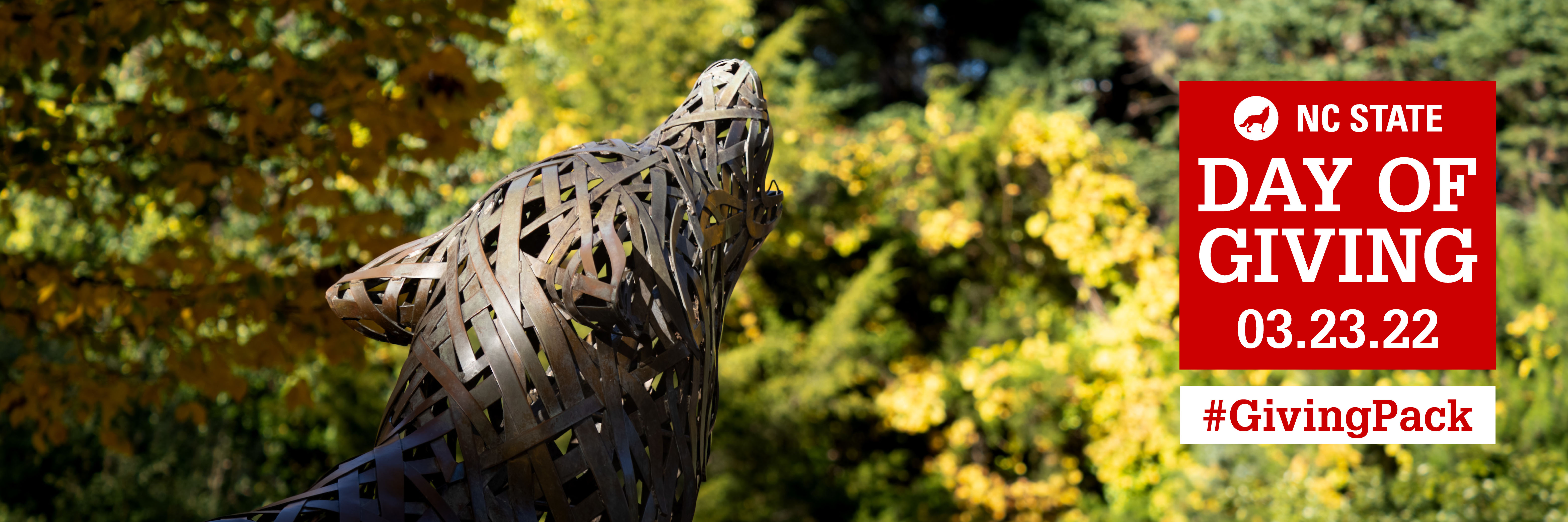 Twitter cover photo with image of the NC State metal wolf and text reading NC State 03.23.22 Day of Giving Hashtag Giving Pack