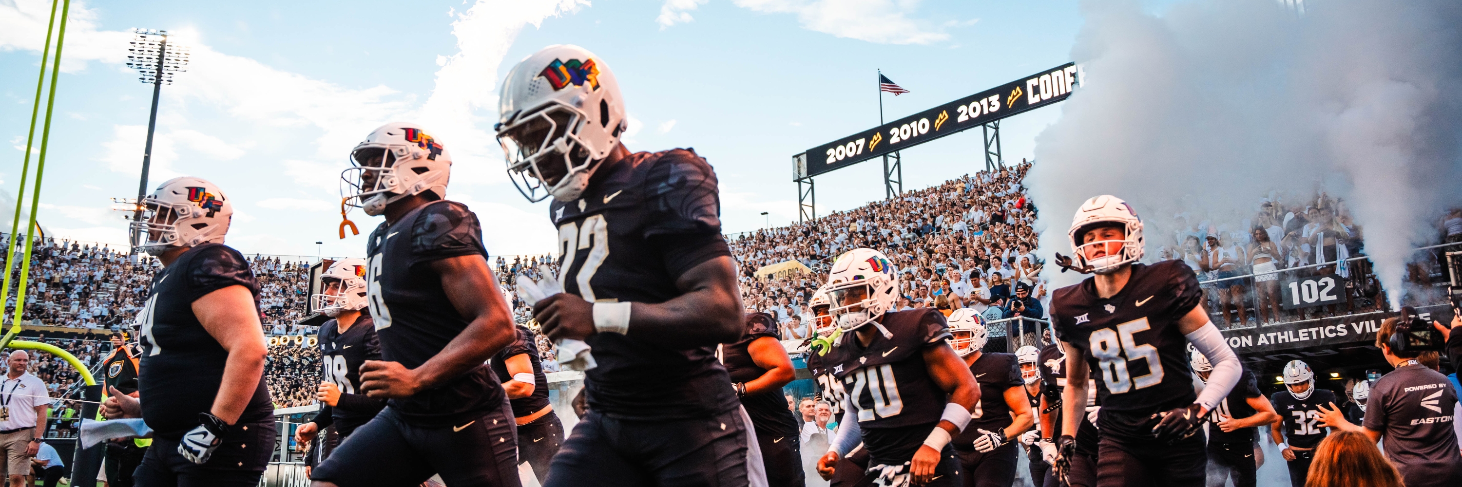 UCF football players running across the field