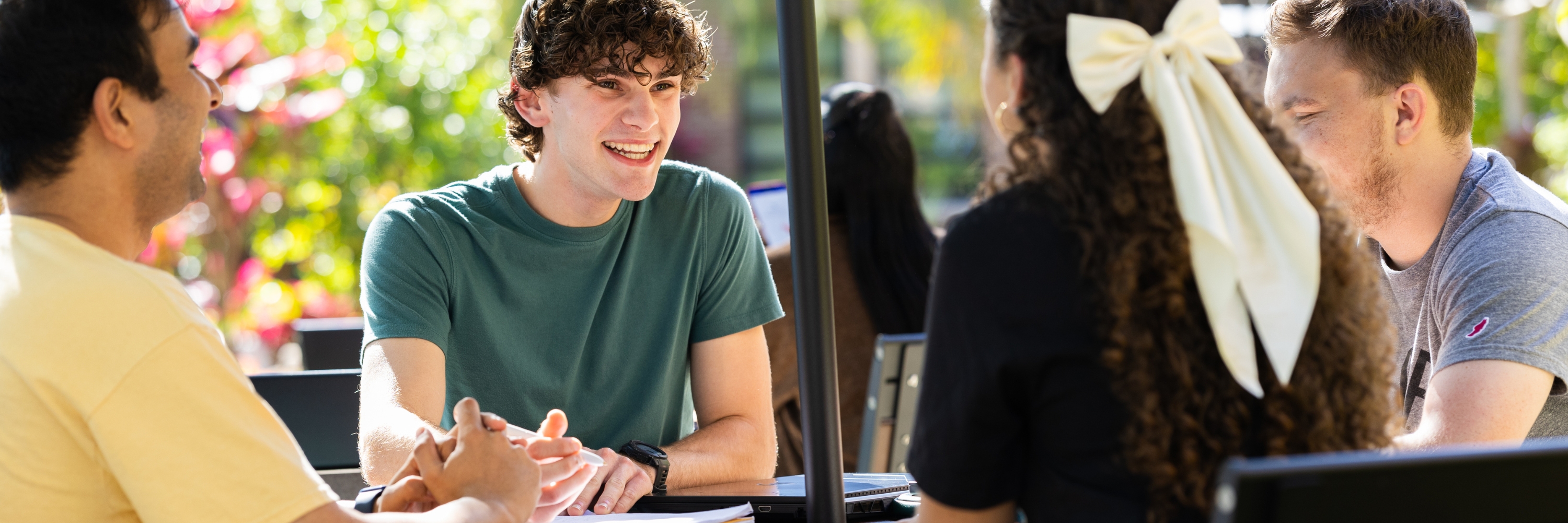 Students sitting around a table outside
